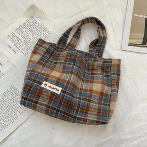 Detail of vintage plaid tote bag with blue and brown checkered thick fabric pattern