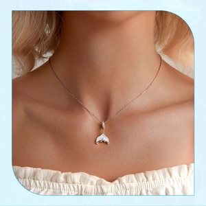 Close-up of s925 silver mermaid tail pendant with opal inlay worn on woman neck