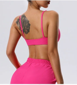 Detail of ribbed hot pink sports bra and high-waisted leggings with open back