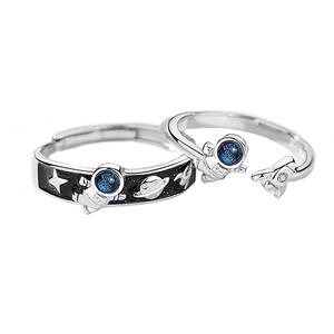 Astronaut theme couple rings set featuring black enamel planet and spaceship charms