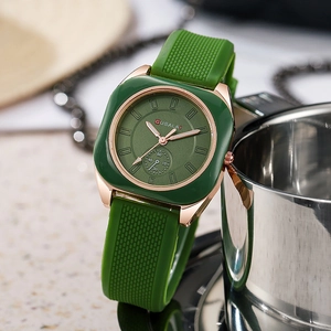 Elegant rose gold and green quartz watch with slim silicone strap in lifestyle setting