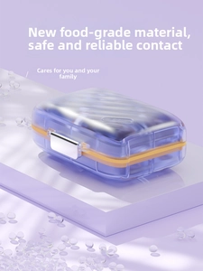 Detail of lavender pill box with diamond texture, orange seal, and silver metal buckle