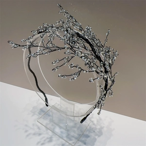Detail of elegant black headband with handmade crystal beads in branch design
