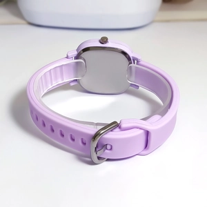 Detailed side view of a light purple square digital watch with flexible silicone strap