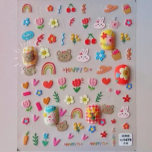 Close-up of 3D embossed nail stickers with cute bear, rabbit and floral doodle patterns
