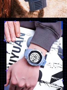 Close-up of multifunctional grey sports watch showing step counter and digital interface