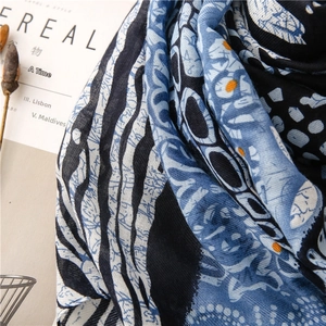 Detailed macro view of exotic blue floral pattern and zebra print on soft cotton scarf