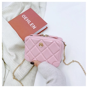 Detailed shot of pink quilted PVC jelly bag with gold chain and rose metal hardware
