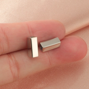 Close-up of small silver hollow rectangular titanium steel beads for DIY jewelry making