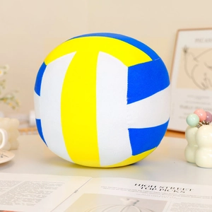 Close-up of plush volleyball pillow featuring yellow, blue, and white soft fabric panels