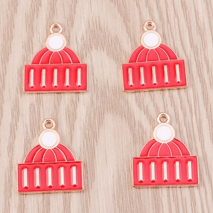 Detail view of four red and white knit hat alloy charms for DIY Christmas jewelry making