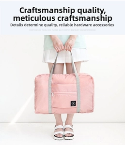 Pink large capacity travel bag with front zipper pocket and durable gray hand straps