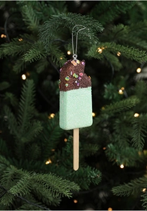 Close-up of a sparkling glitter ice cream Christmas tree ornament on a branch