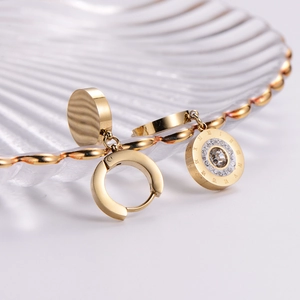 18k gold-plated titanium earrings with roman numerals and crystal pendant on glass shell tray