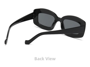 Detail view of black wide-frame sunglasses with hinge and specifications on temples