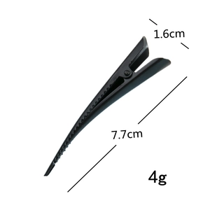 Macro detail of a black beak-shaped hair clip with dimensions 7.7cm by 1.6cm