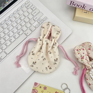 Detailed shot of corduroy floral bunny ear pouch with drawstring and checkered lining