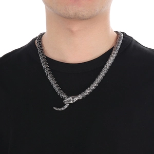 Detailed close-up of a vintage retro snake scale titanium steel chain on a black shirt