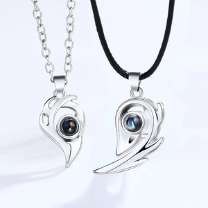 Detail of magnetic couple necklace set with sun moon pendants and projection stone