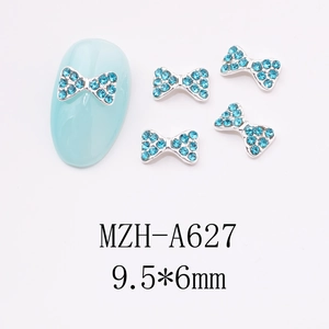 Detail of blue rhinestone bow nail charms with silver metal base and size dimensions