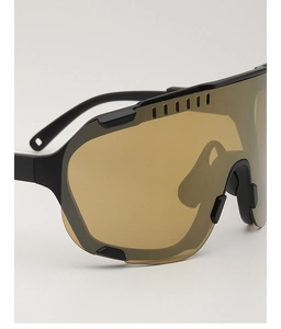 Macro detail of cycling sunglasses featuring matte black frame and top ventilation vents