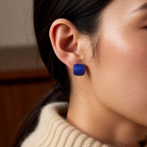 Close-up of vintage blue pavé cubic zirconia square stud earrings on model's ear
