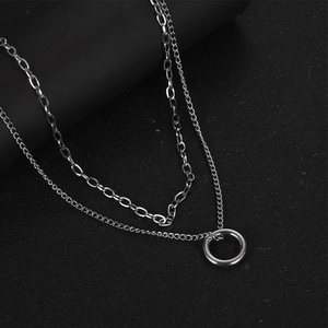 Double-layered silver necklace with rectangular links and a minimalist circle pendant