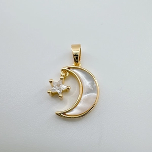 Detail of 18k gold plated moon and star pendant with white shell inlay and zircon