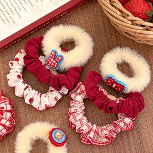 Detail of red plush hair scrunchies with polka dots and cute resin animal charms