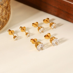 Detailed view of three pairs of graduated size cubic zirconia stud earrings in gold plating