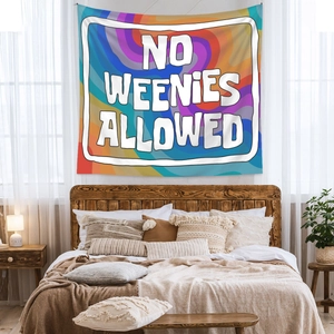 Detail of bohemian psychedelic swirl tapestry with No Weenies Allowed text in a bedroom
