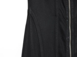 Detail shot of black denim dress fabric texture with high quality metal zipper closure
