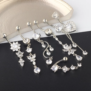 Detailed view of silver belly rings with AAA zircon in heart, flower, and butterfly shapes