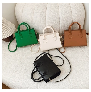 Multiple colors of minimalist PU leather crossbody bags displayed on a soft plush background