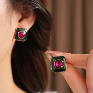 Vintage gold square stud earrings with green enamel frame and red crystal gemstone inlay