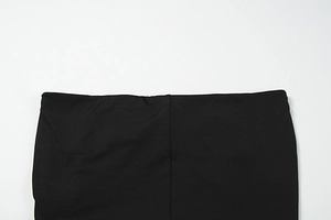 Detail of high-waist elastic waistband on black stretch dress with vertical seam stitch