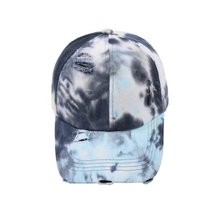 Close-up of tie-dye baseball cap featuring vintage distressed holes and frayed edge detail