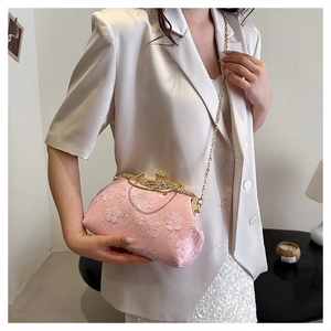 Detailed shot of pink mesh evening bag with 3D floral embroidery and sequins