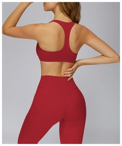 Detail of red racerback yoga sports bra and high-waisted leggings with heather texture
