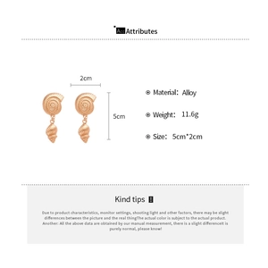 Detailed view of large gold seashell drop earrings with alloy material specifications