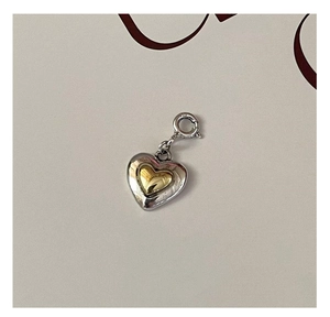 Macro shot of S925 sterling silver dual-tone heart pendant with spring ring clasp
