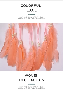 Detail of vibrant orange feathers, wooden beads and ribbons on a woven dreamcatcher