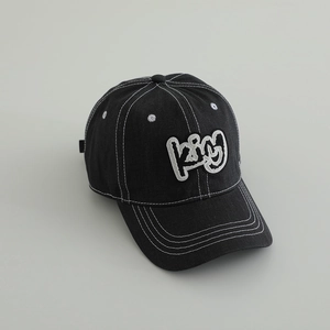 Detailed view of black cotton baseball cap with white contrast stitching and KING embroidery