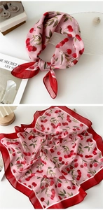 Detail of pink cotton-linen scarf with cherry print and contrast red border