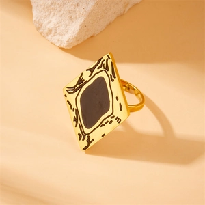 Adjustable gold-plated square ring with black enamel inlay and abstract patterns