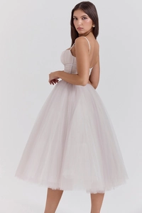 Detail of the pale pink mesh dress featuring a structured corset bodice and thin straps