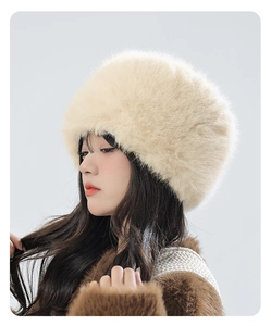 Detail showing the fluffy cream faux fur texture and side profile of the warm trapper hat
