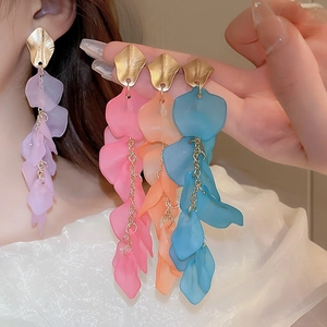 Detail of matte resin flower petal tassel earrings in purple, pink, orange, and blue colors