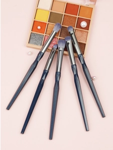 Detail of 5-piece eye makeup brush set with starry blue diamond handles on pink background