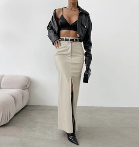 Close-up of beige high-waist faux leather skirt with side slit and matching belt